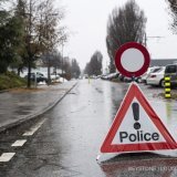 A police warning sign ahaed of a closed road after a shooting in Sion, Switzerland, Monday, December 11, 2023. According to the police of the canton of Valais. An individual fired several shots in Sion on Monday morning, at two separate locations. Two people died and another was injured. An individual fired several shots in Sion on Monday morning, at two separate locations. Two people died and another was injured. (KEYSTONE/Louis Dasselborne)